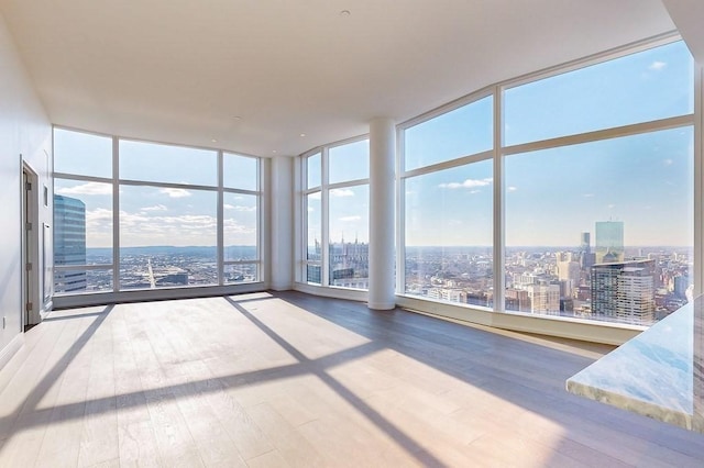 interior space featuring hardwood / wood-style floors and a wall of windows