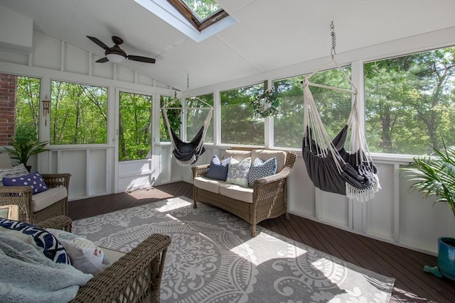 sunroom with an outdoor living space, a ceiling fan, a skylight, lofted ceiling, and healthy amount of natural light