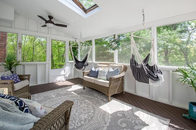 sunroom featuring an outdoor living space, ceiling fan, vaulted ceiling, a skylight, and healthy amount of natural light