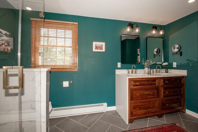 bathroom featuring a baseboard heating unit, baseboards, a marble finish shower, and double vanity