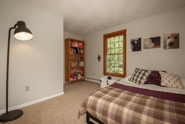 bedroom featuring a baseboard heating unit, light carpet, and baseboards