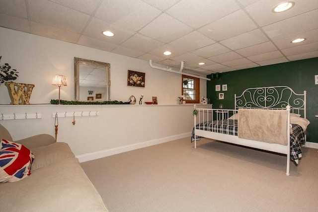 carpeted bedroom with recessed lighting, baseboards, and a drop ceiling