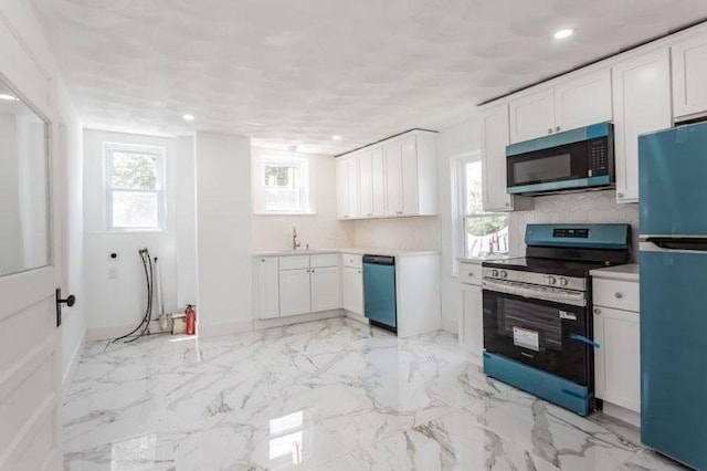 6 Smith St, Taunton, MA 02780 - kitchen with appliances with stainless steel finishes, white cabinetry, light countertops, recessed lighting, and a sink