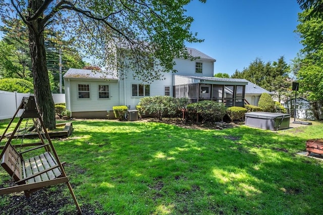 rear view of house featuring a sunroom