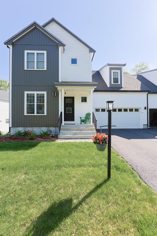 19 Millies Way, Sterling, MA 01564 - modern inspired farmhouse featuring driveway, a front yard, covered porch, board and batten siding, and a garage