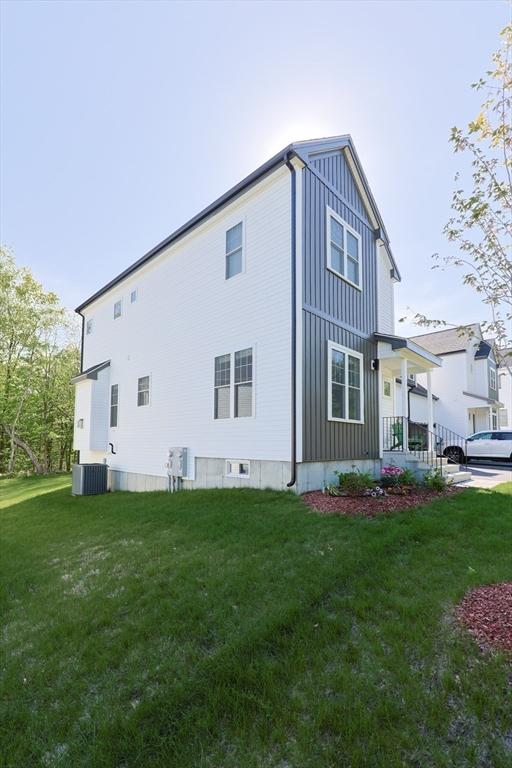 19 Millies Way, Sterling, MA 01564 - view of side of home featuring board and batten siding, cooling unit, and a yard