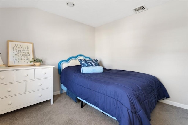 bedroom featuring visible vents, lofted ceiling, light colored carpet, and baseboards