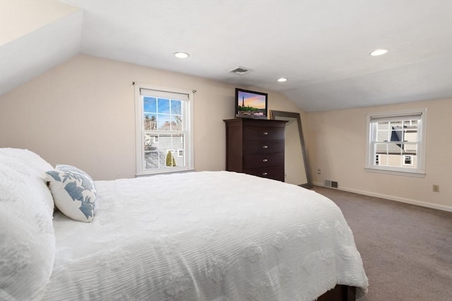 bedroom with visible vents, baseboards, carpet flooring, and vaulted ceiling