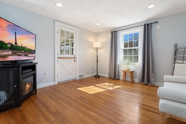 interior space featuring visible vents, recessed lighting, baseboards, and wood finished floors