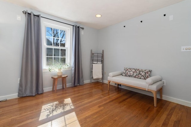 sitting room featuring baseboards and wood finished floors