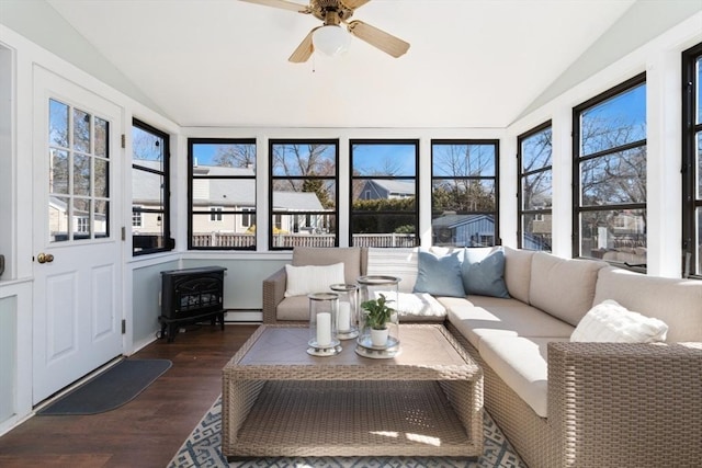 sunroom with baseboard heating, a ceiling fan, and vaulted ceiling