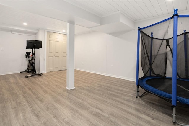 workout area with recessed lighting, wood ceiling, baseboards, and wood finished floors