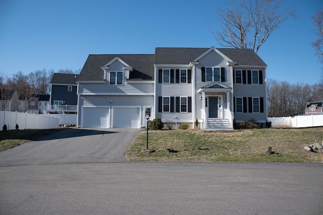 84 Murray Cir, Stoughton, MA 02072 - view of front facade with driveway and a garage