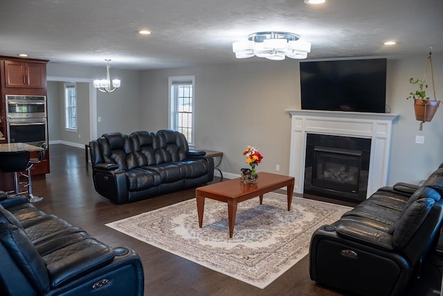 84 Murray Cir, Stoughton, MA 02072 - living area with a chandelier, plenty of natural light, recessed lighting, a fireplace with flush hearth, and dark wood-style floors