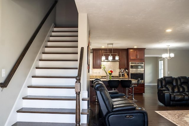 84 Murray Cir, Stoughton, MA 02072 - staircase with baseboards, wood finished floors, recessed lighting, and a chandelier