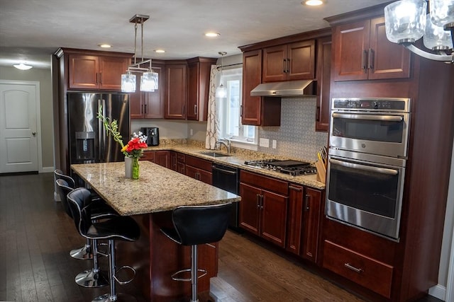 84 Murray Cir, Stoughton, MA 02072 - kitchen with appliances with stainless steel finishes, under cabinet range hood, a sink, dark wood-type flooring, and recessed lighting