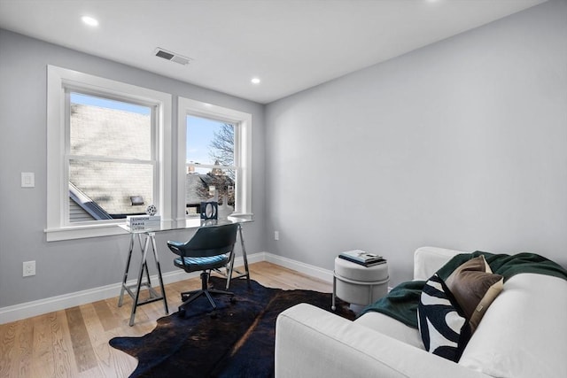 office space featuring visible vents, baseboards, recessed lighting, and wood finished floors