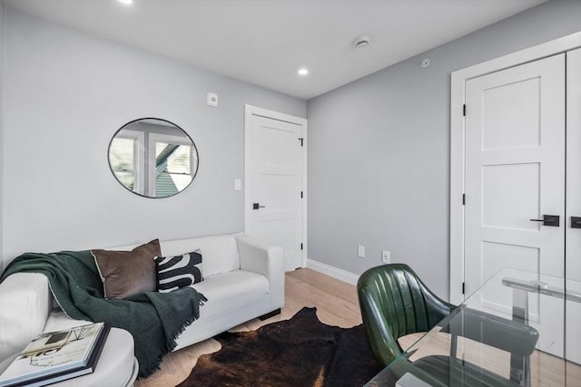 office area featuring baseboards, light wood finished floors, and recessed lighting
