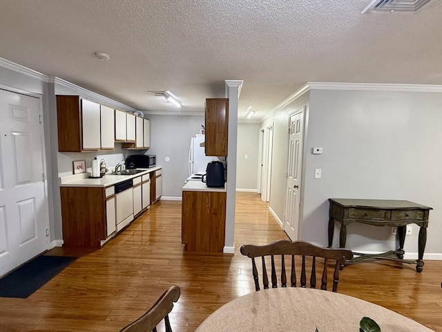 kitchen featuring sink, white appliances, and crown molding