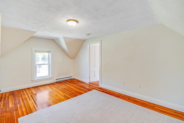 514 W Britannia St, Taunton, MA 02780 - additional living space with a baseboard radiator, vaulted ceiling, hardwood / wood-style flooring, and a textured ceiling