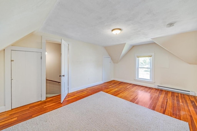 514 W Britannia St, Taunton, MA 02780 - additional living space featuring a baseboard radiator, hardwood / wood-style flooring, vaulted ceiling, and a textured ceiling
