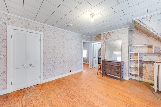 514 W Britannia St, Taunton, MA 02780 - bedroom featuring light wood finished floors, crown molding, wallpapered walls, and a closet
