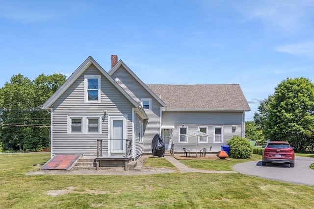 514 W Britannia St, Taunton, MA 02780 - back of property featuring a chimney, a lawn, and a shingled roof