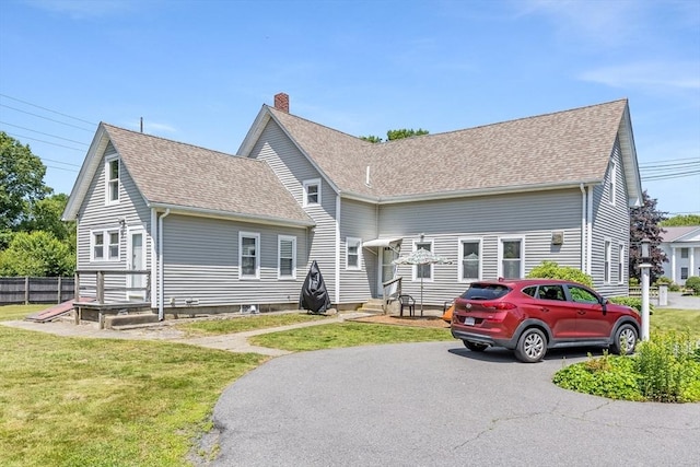 514 W Britannia St, Taunton, MA 02780 - view of front of property featuring roof with shingles, a front lawn, and a chimney