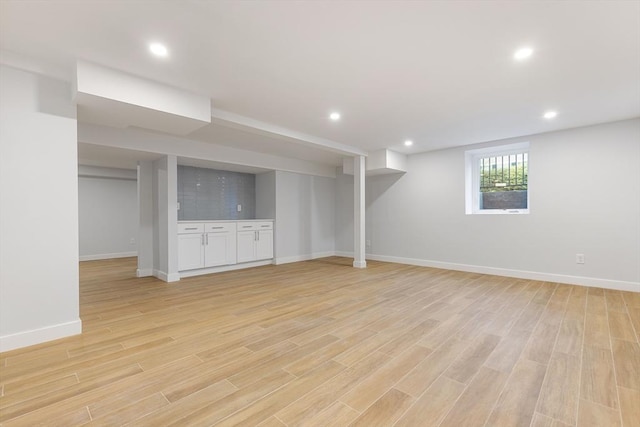 interior space featuring recessed lighting, baseboards, and light wood finished floors