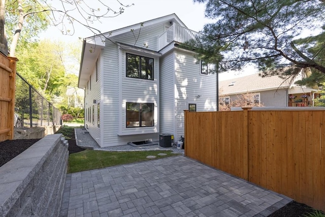 back of house featuring a patio area, fence, and cooling unit