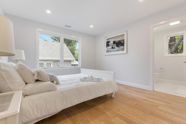 bedroom with baseboards, multiple windows, recessed lighting, and light wood-style floors