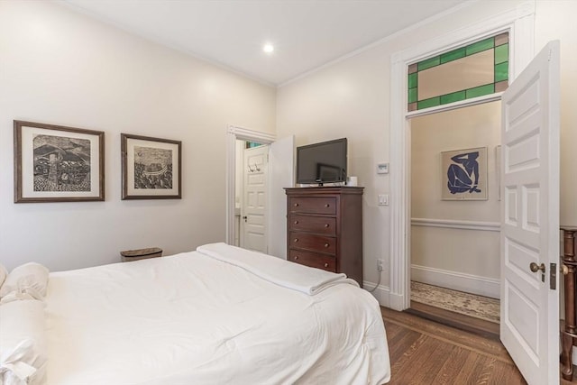 bedroom with dark wood-type flooring and ornamental molding