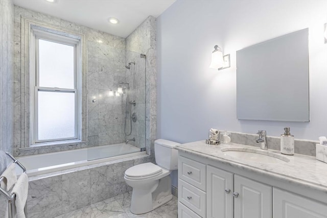 full bathroom with toilet, vanity, and tiled shower / bath combo