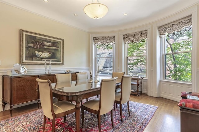 dining area with light hardwood / wood-style floors and a wealth of natural light