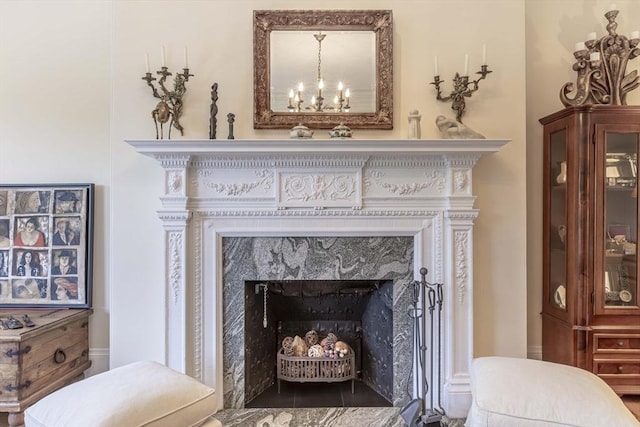 details with a fireplace and a chandelier