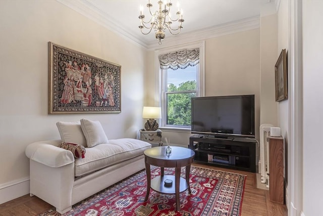 living room with ornamental molding, wood-type flooring, and a notable chandelier