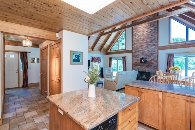 271 Rte 87, Columbia, CT 06237 - kitchen featuring stone finish flooring, wooden ceiling with exposed beams, a fireplace, a kitchen island, and light stone countertops