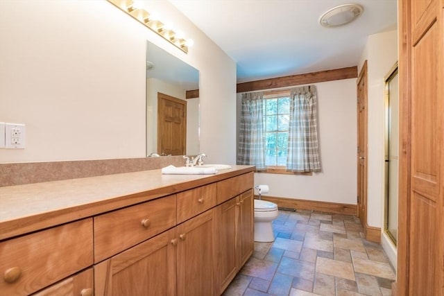 271 Rte 87, Columbia, CT 06237 - full bath with stone finish flooring, toilet, vanity, baseboards, and a shower with door