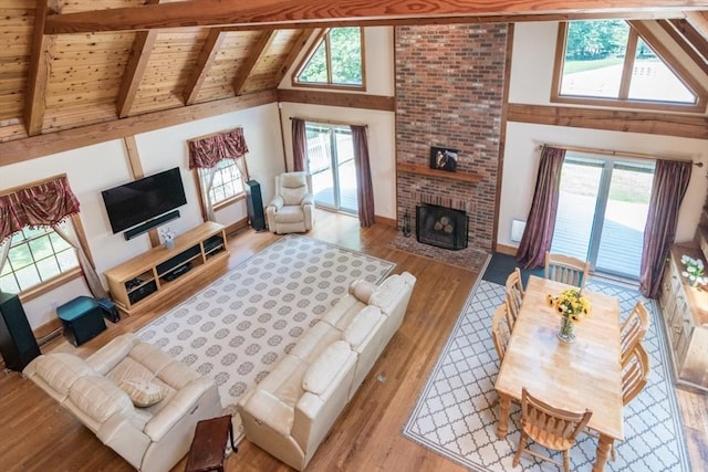 271 Rte 87, Columbia, CT 06237 - living room featuring a fireplace, high vaulted ceiling, wood finished floors, plenty of natural light, and wooden ceiling with exposed beams