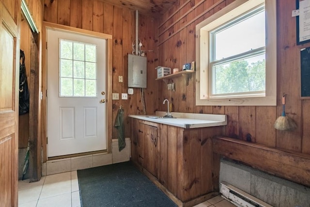 271 Rte 87, Columbia, CT 06237 - kitchen with electric panel, brown cabinetry, wood walls, light tile patterned floors, and light countertops