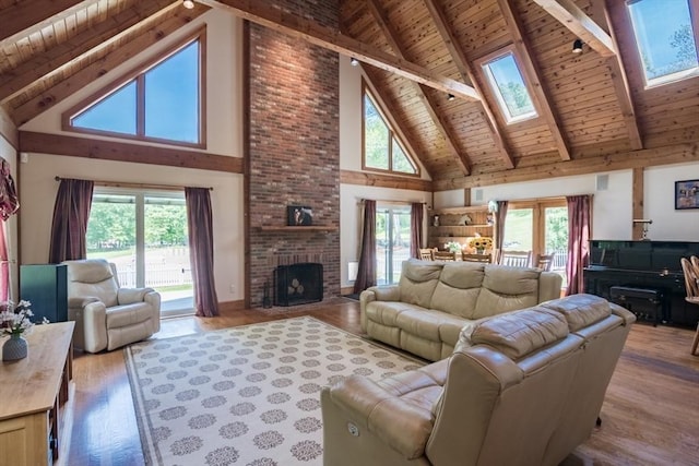 271 Rte 87, Columbia, CT 06237 - living area featuring wood ceiling with exposed beams, high vaulted ceiling, a fireplace, wood finished floors, and a skylight