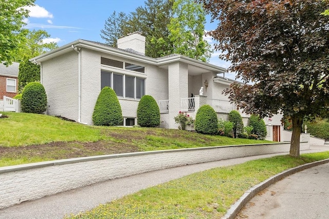 0 E Border Cir, Medford, MA 02155 - view of property exterior with a chimney, brick siding, and a lawn