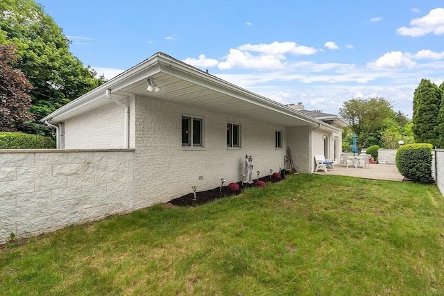 0 E Border Cir, Medford, MA 02155 - rear view of house with a patio and brick siding