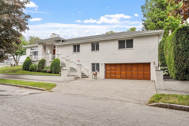 0 E Border Cir, Medford, MA 02155 - view of front of home with asphalt driveway, a garage, and a chimney