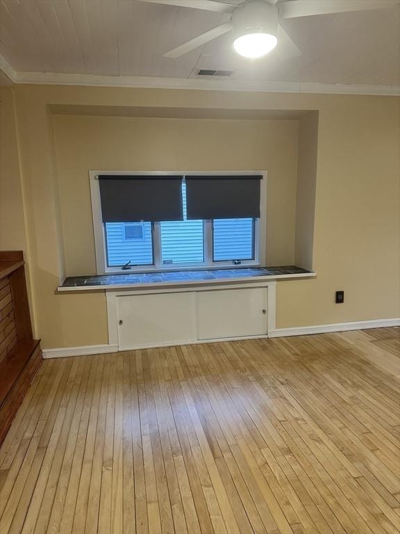 unfurnished room with light hardwood / wood-style flooring and crown molding