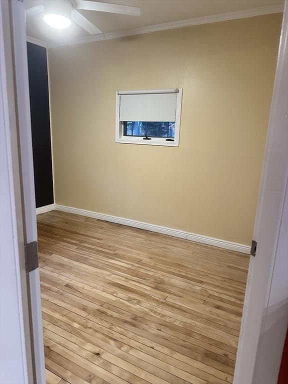 empty room with ceiling fan, light wood-type flooring, and crown molding