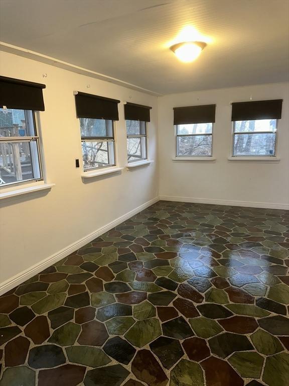 unfurnished room featuring a wealth of natural light