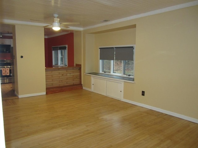 unfurnished living room with ceiling fan, light wood-type flooring, and ornamental molding