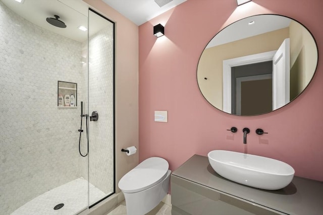 bathroom with vanity, a shower stall, and toilet