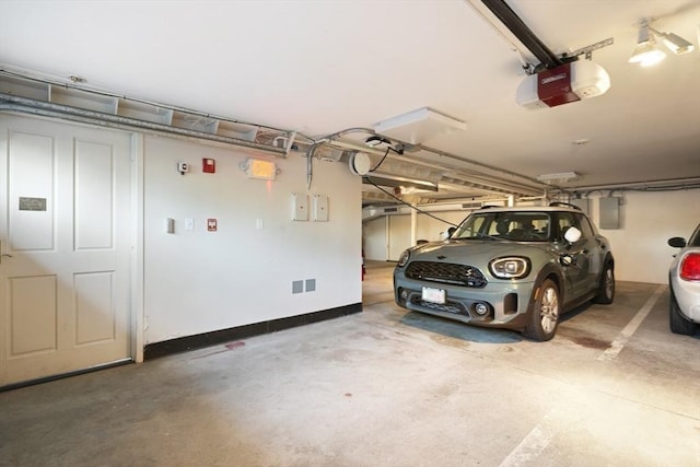 parking garage with electric panel and a garage door opener